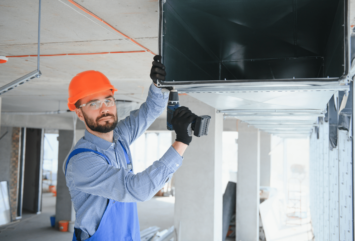 man installing a custom sheet metal HVAC system